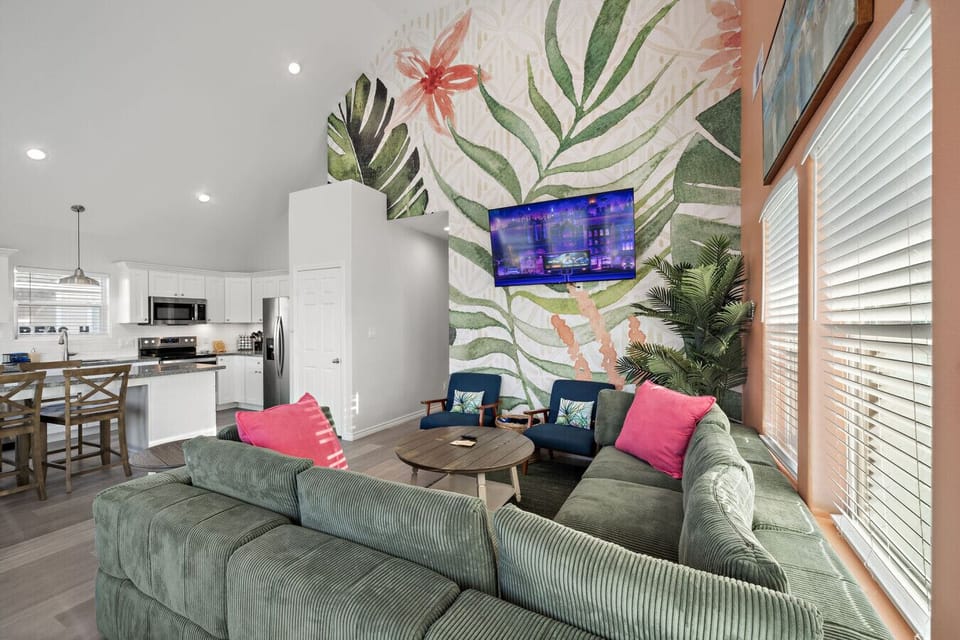 Bright living room with sofa seating and natural light.