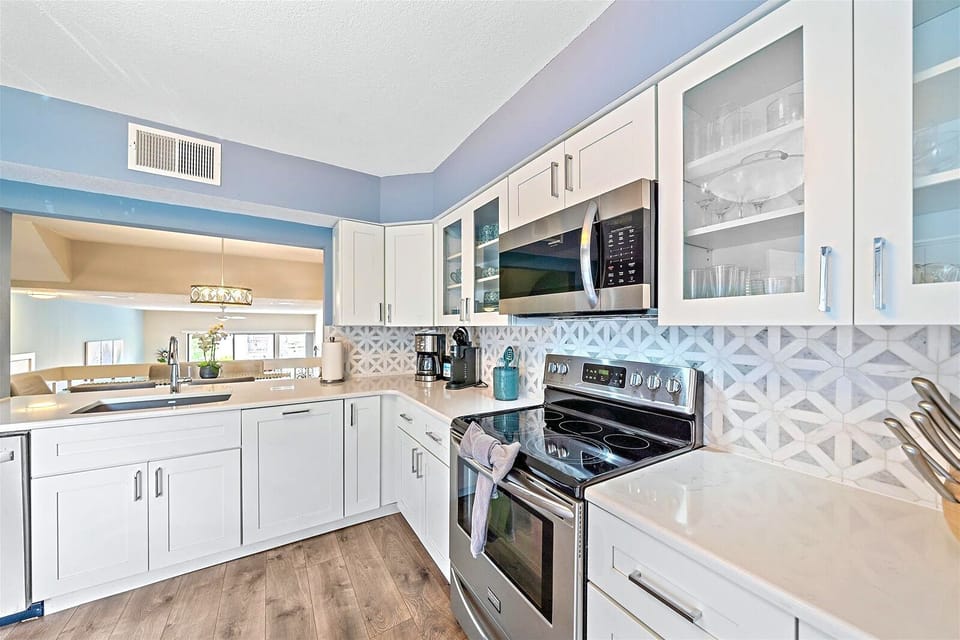 Kitchen overlooks the dining area and is fully stocked for at home meal preparation
