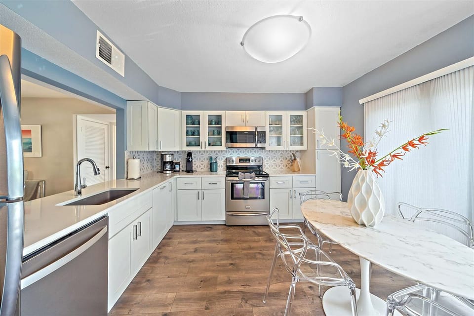 Fully-stocked kitchen with seating area and balcony access