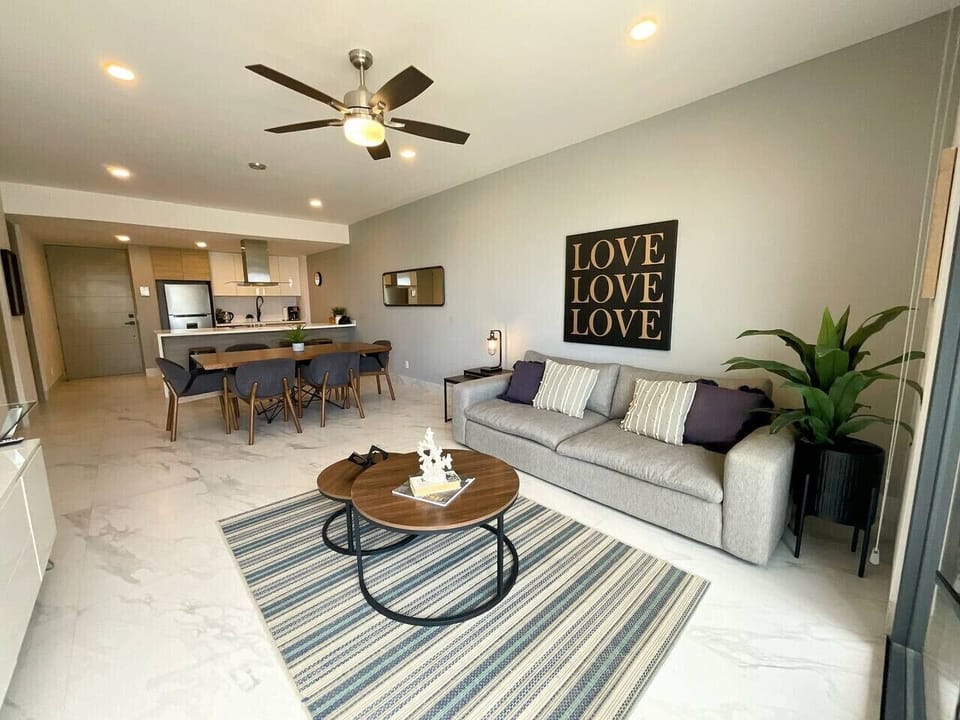 Open-concept design that seamlessly connects the living room, dining area, and kitchen, creating a modern and inviting atmosphere