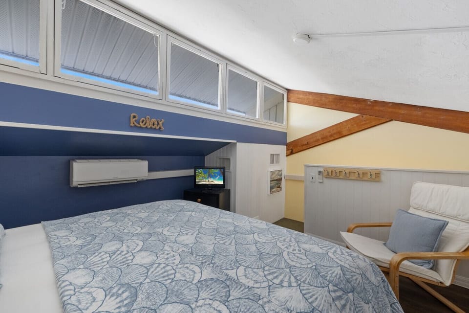 Open loft bedroom area with king bed