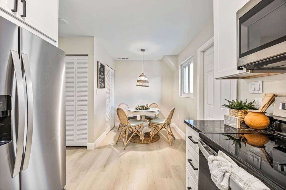 Cozy dining nook with rattan chairs and natural light in a modern kitchen.