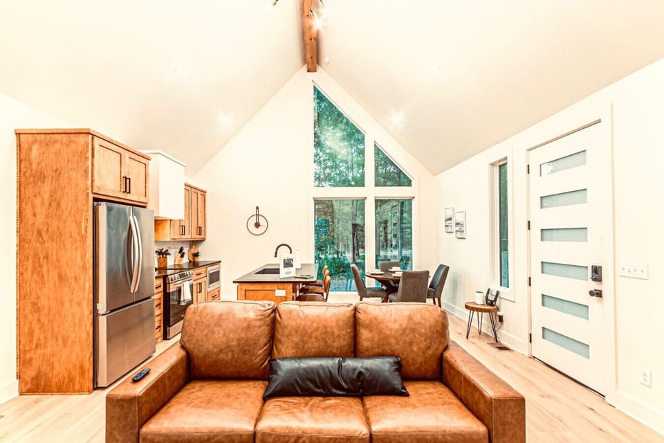 Living Room: Enjoy stunning views through large windows and a stylish, inviting space to unwind!