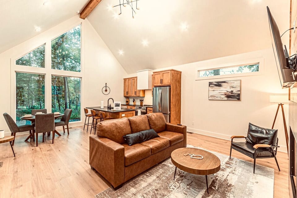 Living Room: Bright, modern space with floor-to-ceiling windows and a stylish open layout!