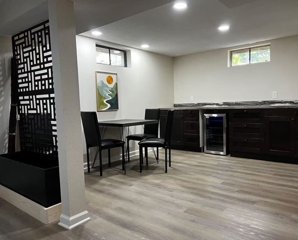 Lower-level kitchenette with dining table, beverage fridge & extra space.