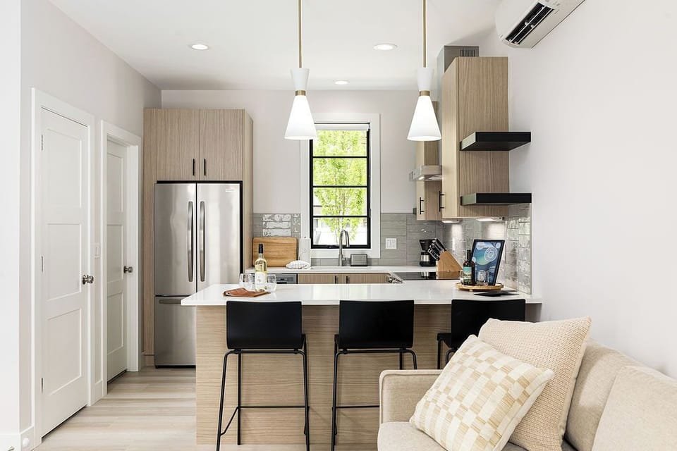 Enjoy the airy ambiance of this contemporary kitchen, complete with top-of-the-line appliances and ample counter space.
