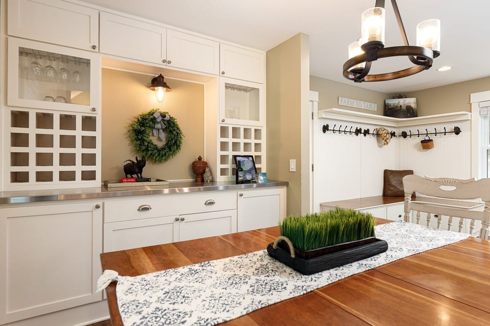 Charming entry nook w/ bench seating, hooks & a welcoming wreath accent.