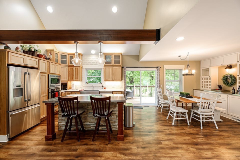 Open kitchen & dining area w/ wood beams, central island & plenty of space to connect.
