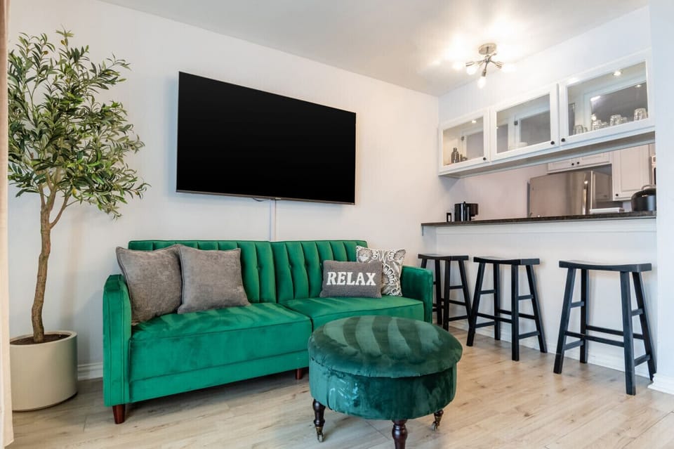 Living area with a green fold down sofa and a queen pullout sofa sleeps 3!
