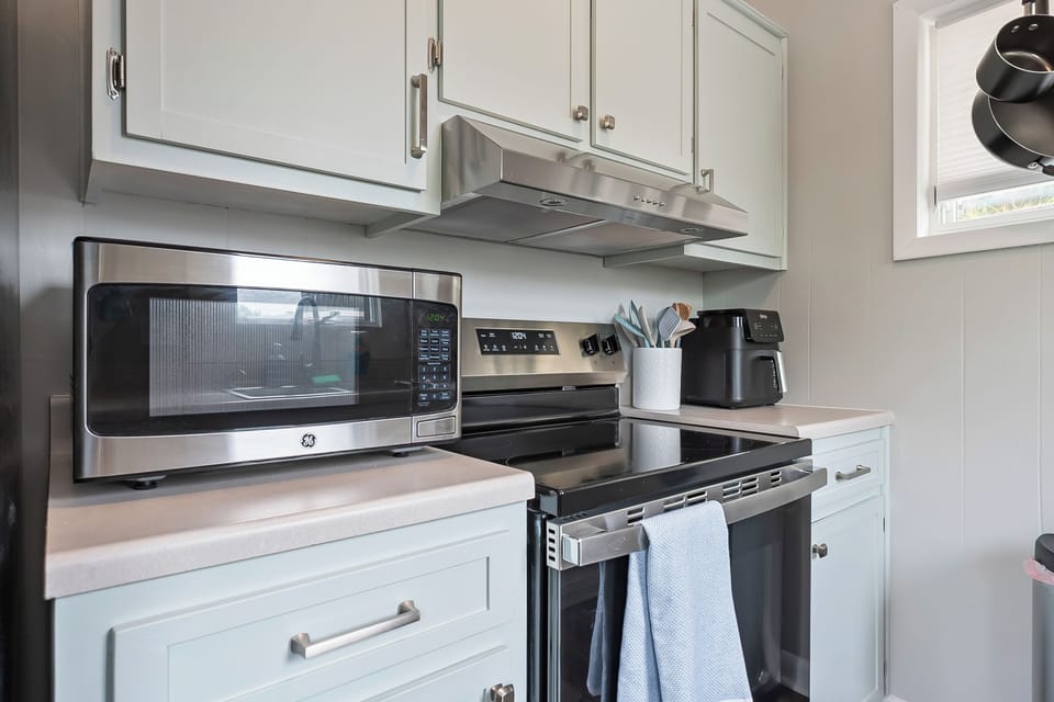 Microwave and air fryer setup in a compact kitchen layout.