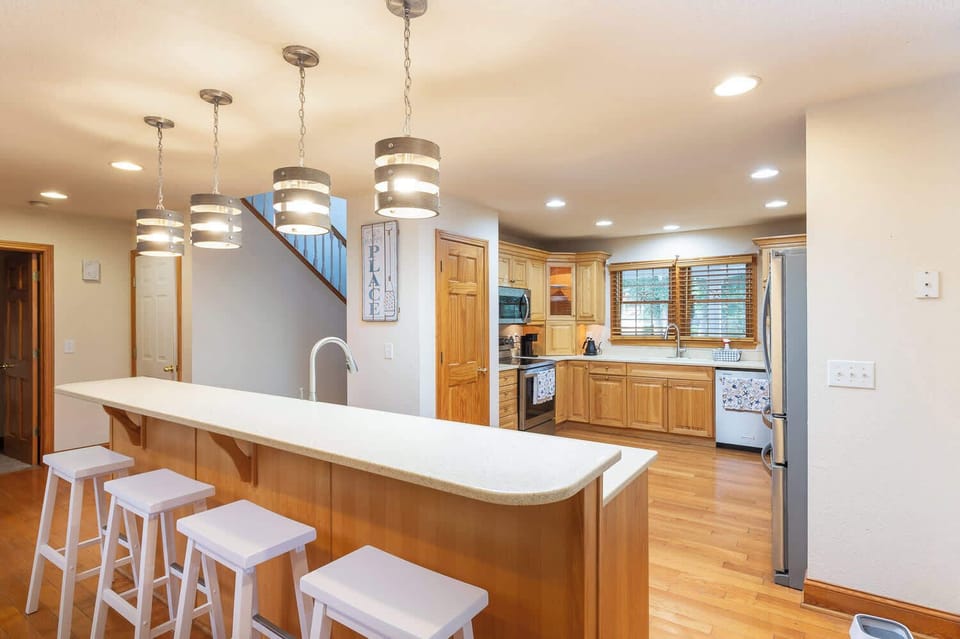 Mid Level: Fully Stocked Kitchen with bar seating and open layout - great for casual meals, morning coffee, or gathering with family and friends.