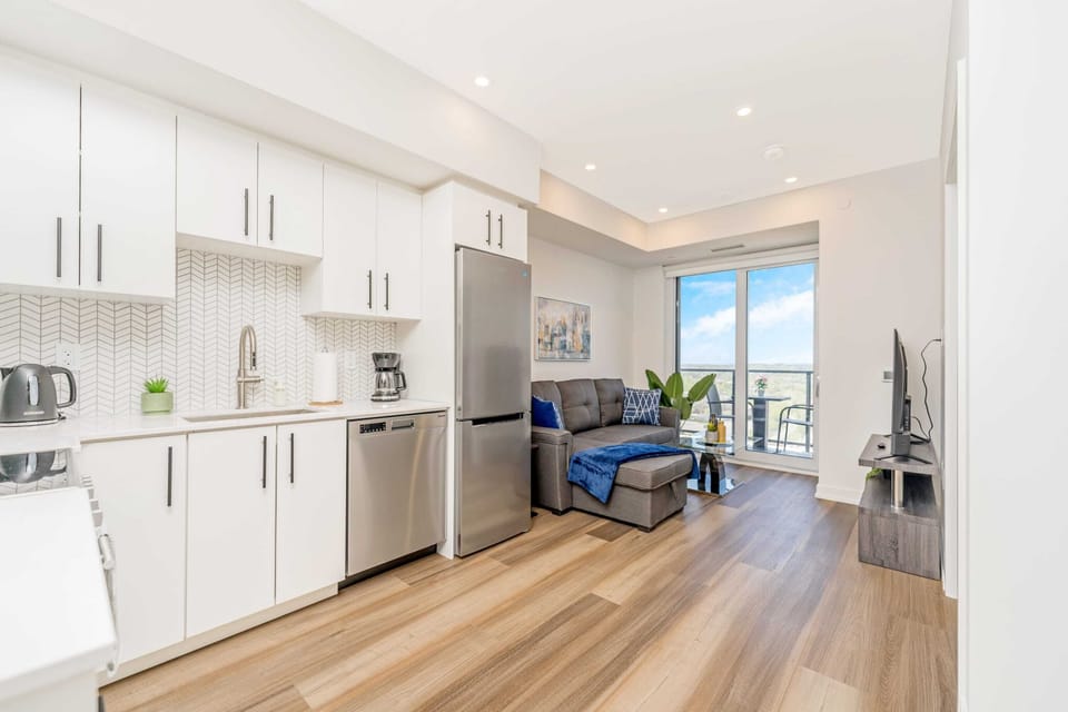 Fully Equipped Kitchen With Quartz Countertops And Stainless Steel Appliances