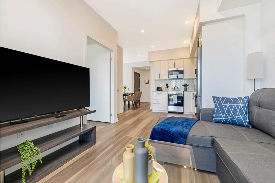 Open Concept Living Area With Sleek Finishes And Natural Light