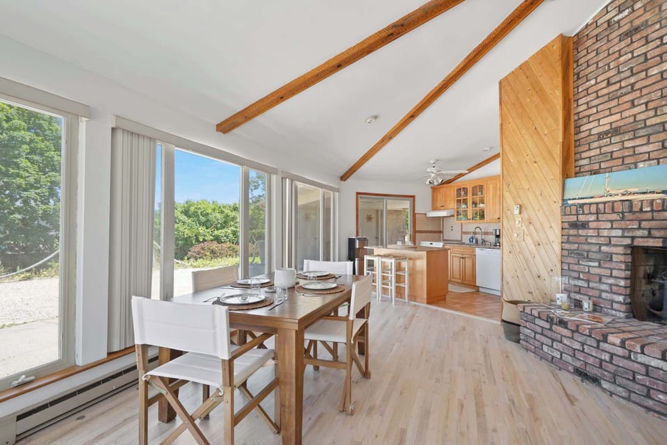 Open living and dining with brick fireplace