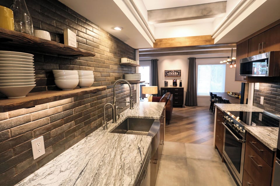 Sleek, modern galley kitchen featuring brand-new, high-end appliances.