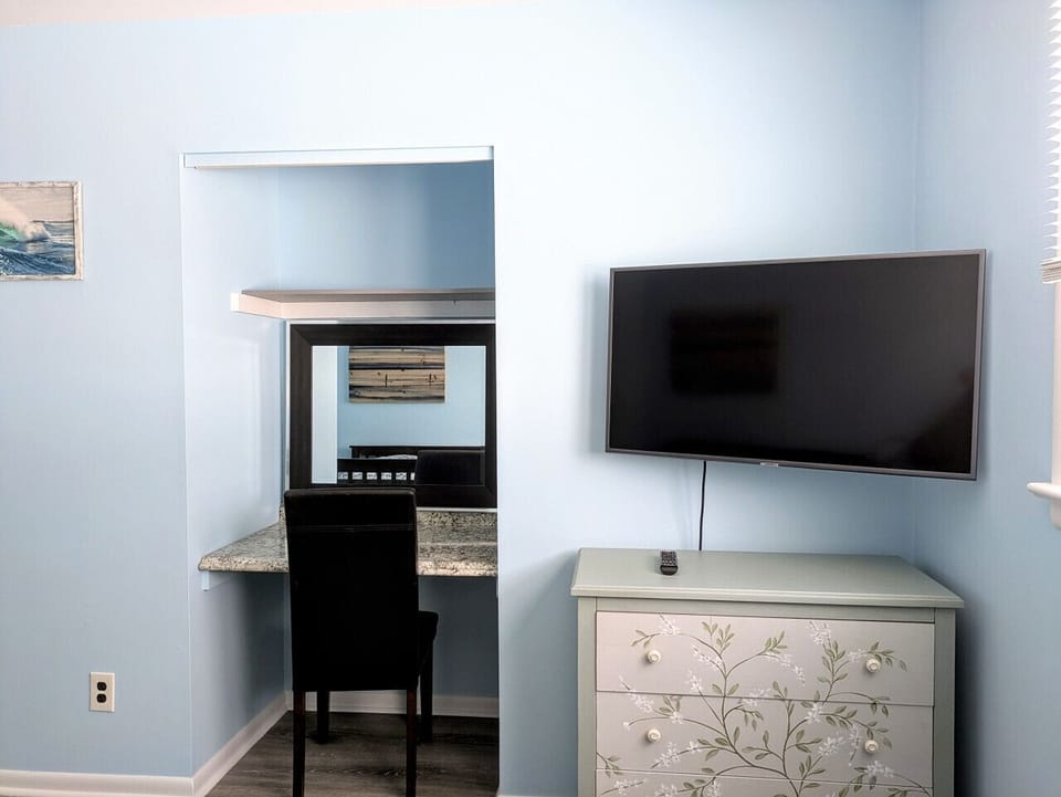 The secondary bedroom also features a TV and workstation.