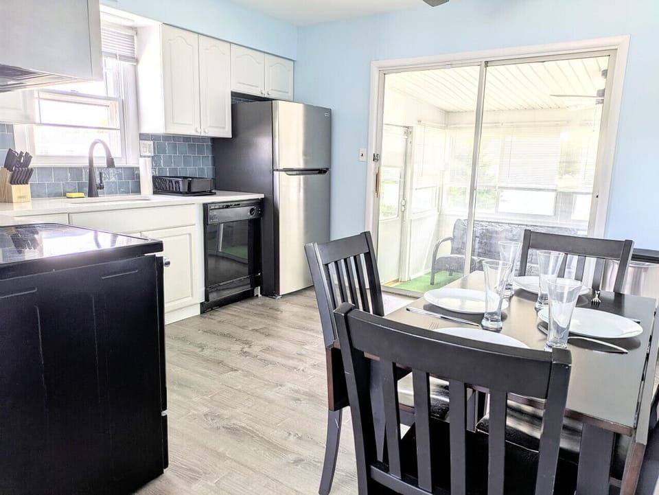 The kitchen leads from the living room to the back sunroom.