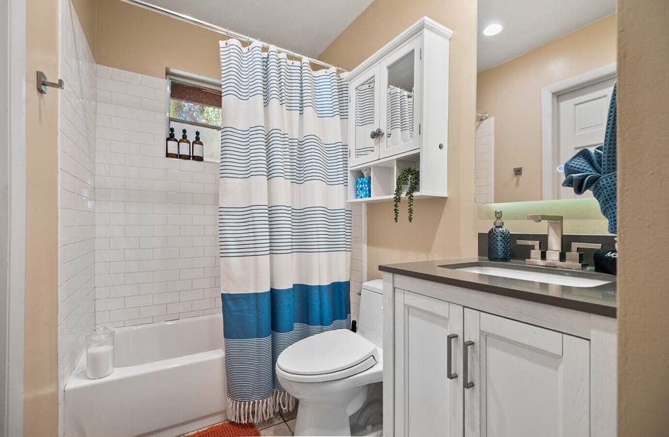 Family-friendly bathroom with a spacious tub/shower combo—ideal for little ones` bath time or a relaxing soak. Essentials like towels and toiletries included!