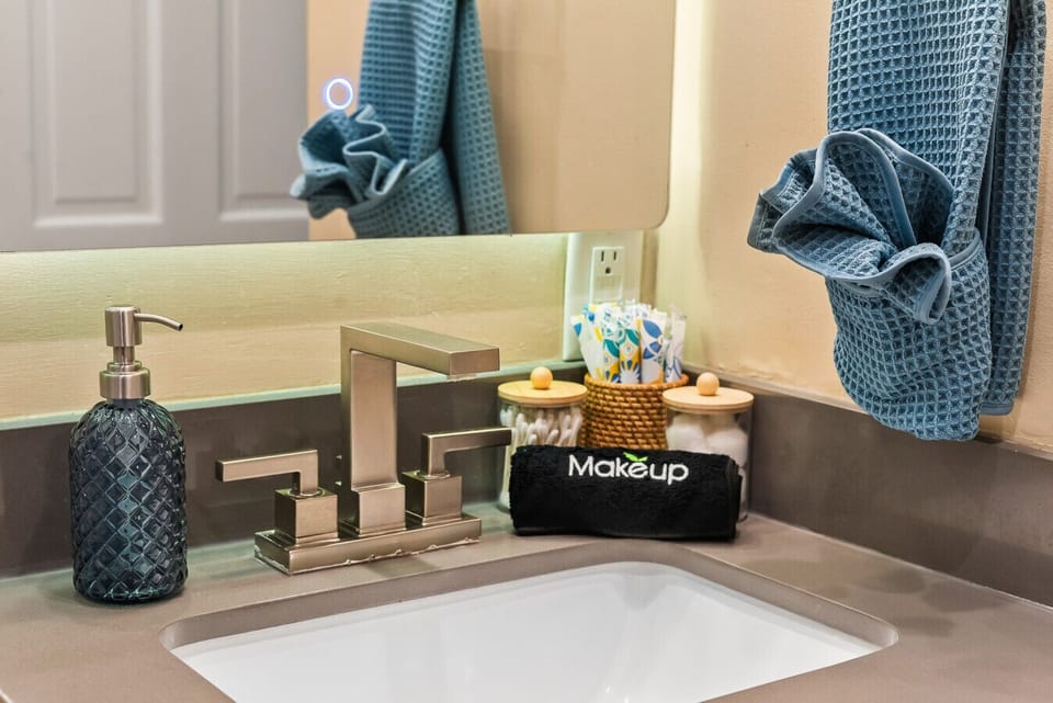 Enjoy a well-equipped bathroom sink area with essential toiletries like tampons, cotton buds, and more to make your stay hassle-free.