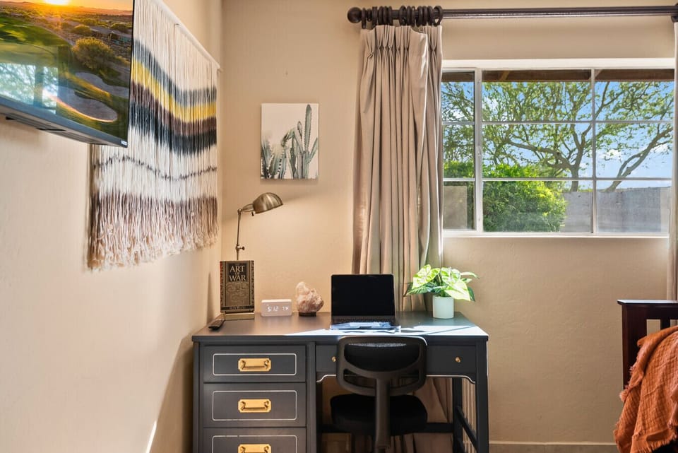 Whether you’re working remotely or catching up on emails, this well-equipped office nook with desk, chair, lamp, and Smart TV offers the perfect balance of focus and comfort.