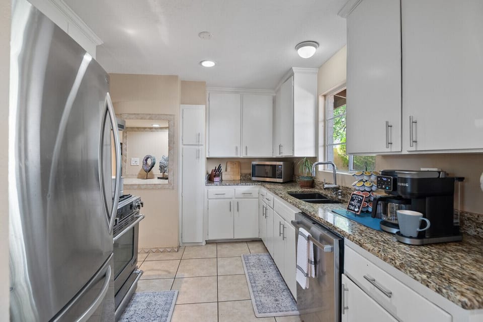 Whip up home-cooked meals in this fully equipped kitchen featuring a full-size refrigerator/freezer, oven with range, dishwasher, and all the cookware, utensils, and dinnerware you need for a seamless cooking experience.
