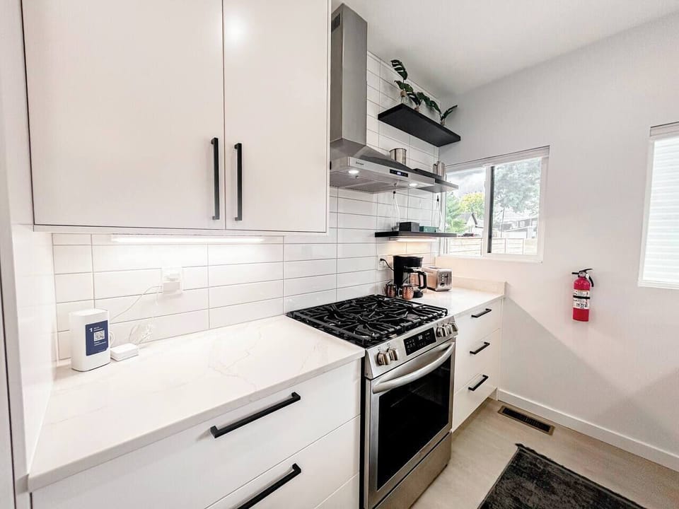The kitchen combines full-size stainless steel appliances, generous counter space, and modern finishes, making meal preparation simple whether you're cooking a quick breakfast, preparing dinner, or entertaining guests.
