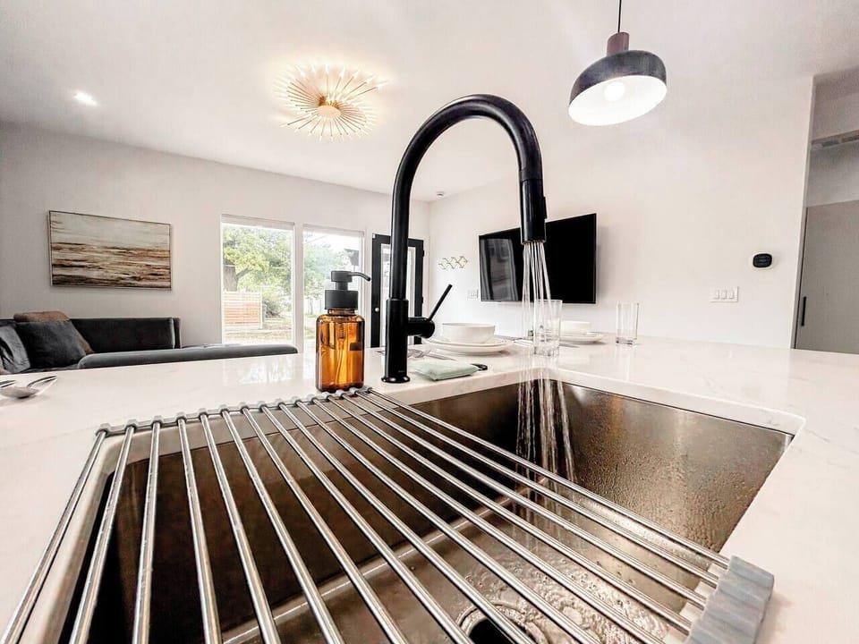 The oversized sink and generous counter space make meal prep and cleanup easy, while the open-concept design keeps you connected to the living and dining areas throughout the day.