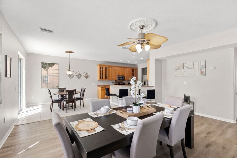 Dining & Kitchen Area | Open-concept space with dining table for eight, breakfast bar seating, and additional dining nook by large windows