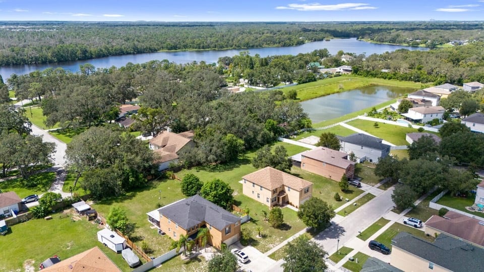 Aerial View | Overhead shot showing home, large backyard, patio with seating and fire pit, and spacious driveway