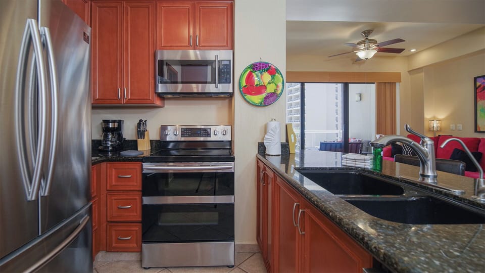The kitchen offers all appliances, rich counter tops and cabinetry.