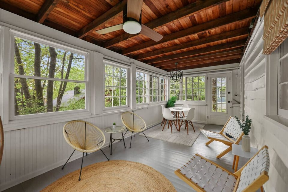 Spacious porch area with rustic wood-beam ceilings, perfect for morning coffee or evening relaxation.