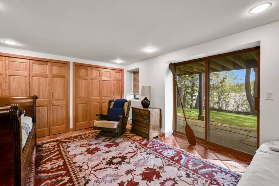 Cozy shared sleeping space with large windows and warm wood accents.