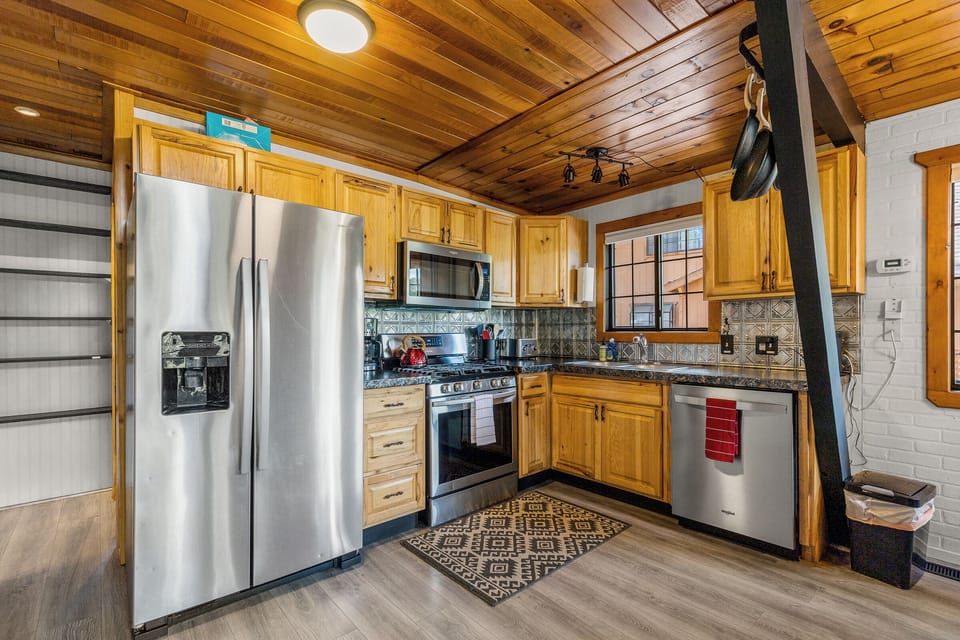 Full kitchen with gas range stainless appliances. 