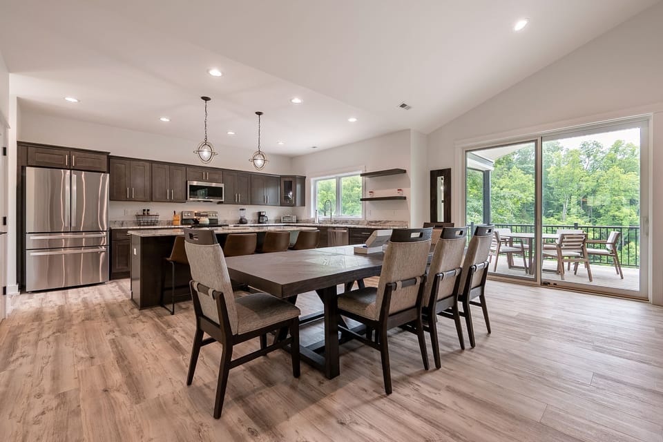Open-concept kitchen with long dining table.