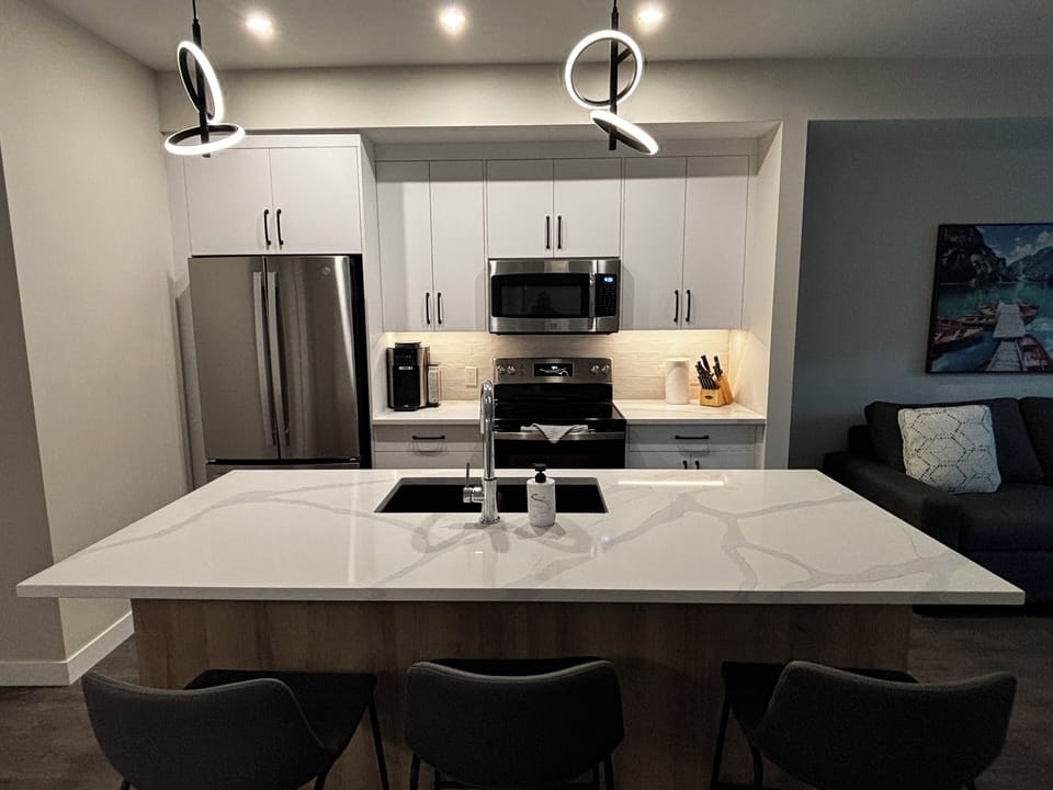 Fully stocked kitchen. Dining area on peninsula.