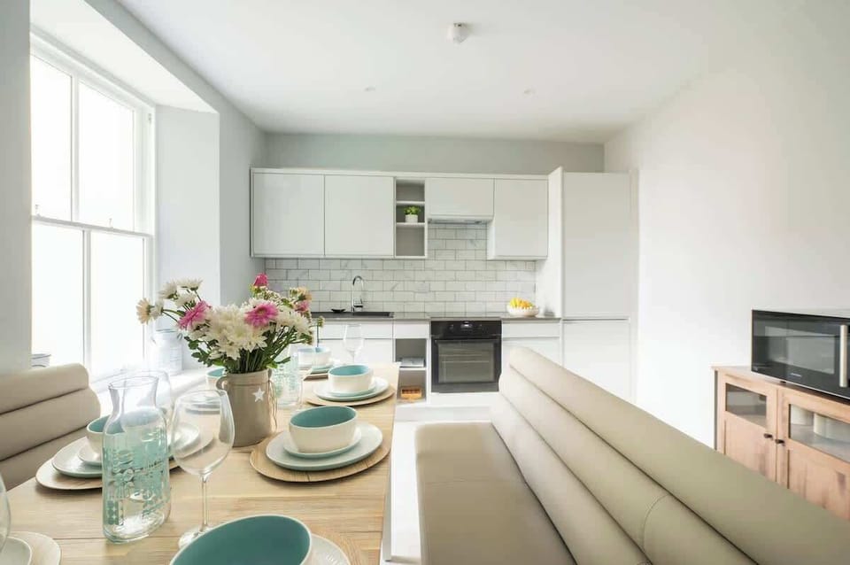 A fully equipped kitchen featuring all the essentials and modern appliances, perfect for family meals. This bright space overlooks the courtyard, providing an ideal setting for cooking together.