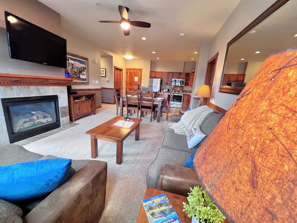 Living room with gas fireplace and mountain views.
