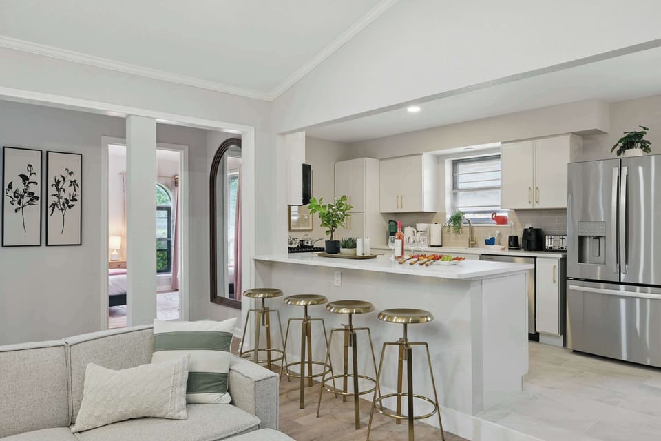 Fully stocked kitchen with sleek appliances and a bar area for casual bites or cocktails.