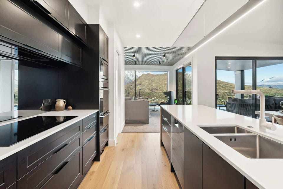 Chef’s kitchen with seamless indoor-outdoor flow and panoramic mountain vistas.