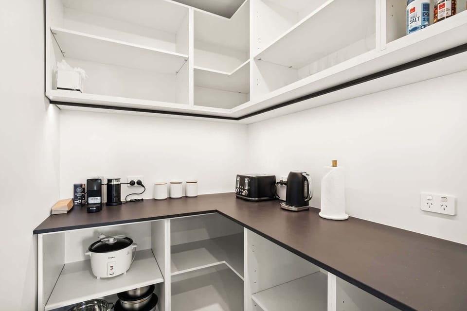 A fully stocked butler’s pantry, complete with coffee machine, toaster, and rice cooker.