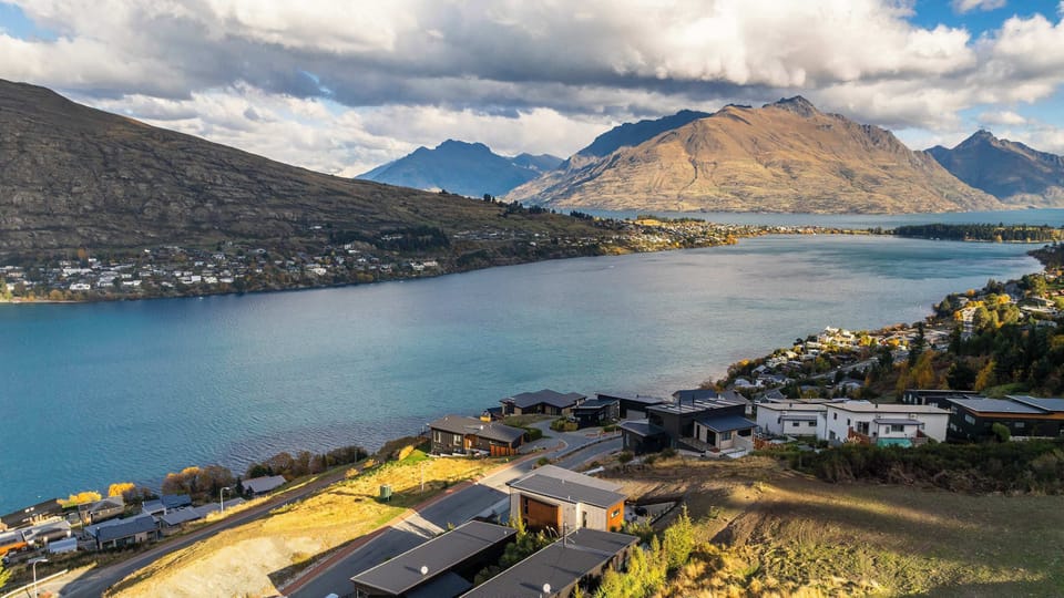 Aerial view showcasing the elevated position of the home with sweeping lake and mountain vistas over Queenstown and the surrounding region.