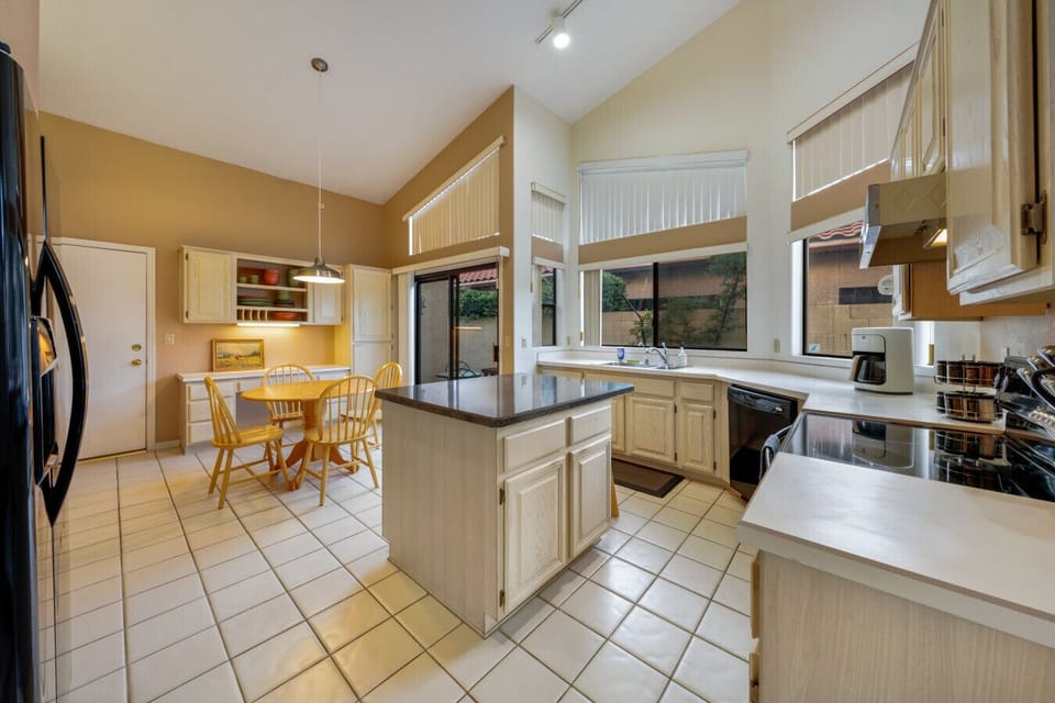 Well-equipped kitchen with table for four and island with additional seating
