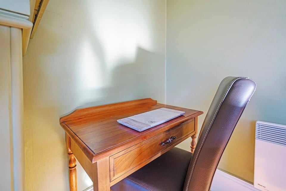 Find a quiet corner to jot notes, journal, or catch up on emails at the dedicated writing desk tucked just off the hallway.
