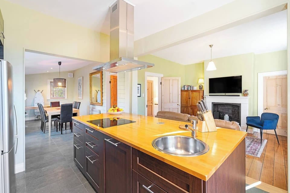 Whether you’re prepping a platter or pouring wine, the expansive island offers a central hub for gathering and hosting.