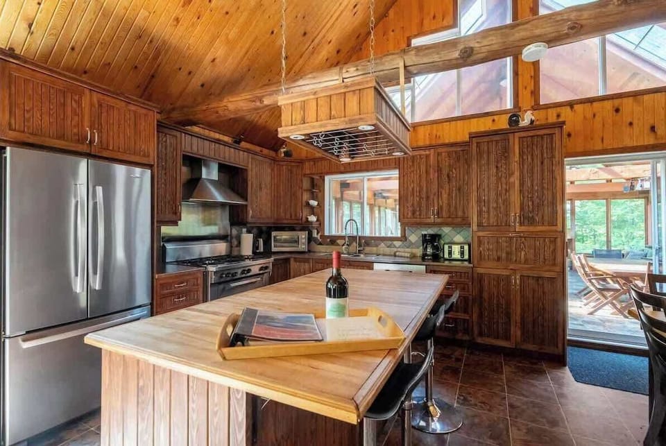 Central island and stainless appliances built for group cooking and snacking