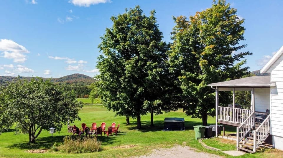 Adirondack chairs around the firepit, perfect for sunset views