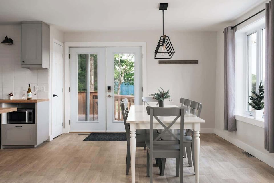 Bright dining area with access to the outdoor space, offering a peaceful setting.