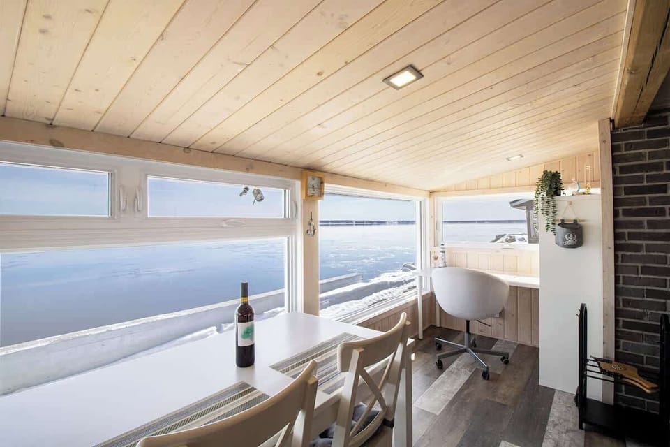 Elegant dining space with panoramic views of the tranquil rive