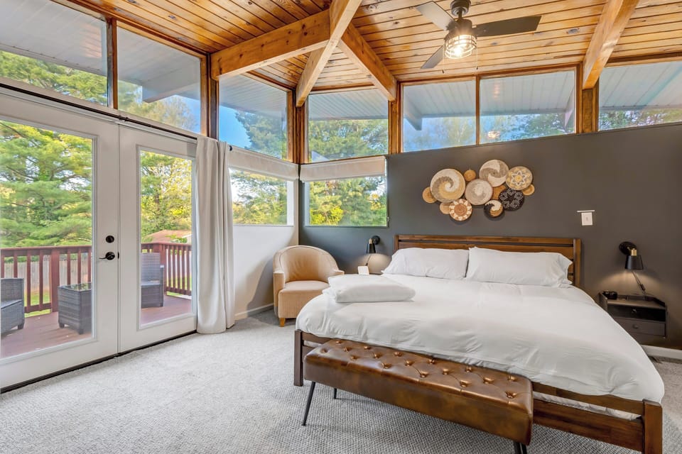 Primary bedroom with vaulted ceilings and peaceful views.