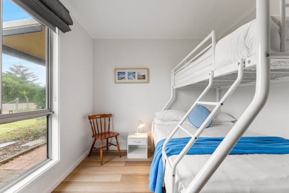The third bedroom is ideal for families, featuring a tri-bunk with a double bed below and a single above for flexible sleeping arrangements.